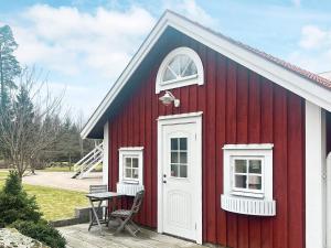 una casa roja con una puerta blanca y una mesa en Holiday home VÄXJÖ II en Växjö