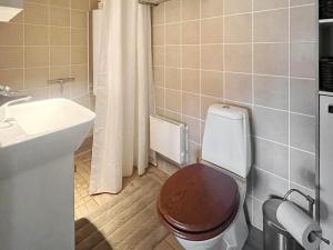 a bathroom with a toilet and a sink at Holiday home VÄXJÖ II in Växjö