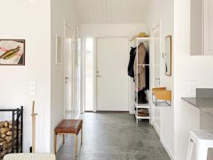 einen Flur mit Tür und Stuhl in einem Zimmer in der Unterkunft Holiday home VAXHOLM II in Vaxholm