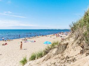 a group of people on a beach with the ocean at 4 person holiday home in FALKENBERG-By Traum in Falkenberg