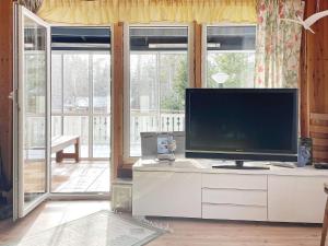 a living room with a flat screen tv on a dresser at 7 person holiday home in GRISSLEHAMN-By Traum in Grisslehamn