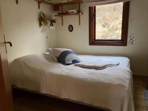 a mermaid laying on a bed in a bedroom at Holiday home Nösund VI in Nösund