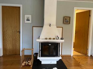 a fireplace in a living room with a stove at Holiday home Nösund VI in Nösund