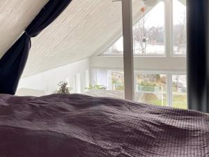 a bedroom with a bed and a large window at 5 star holiday home in Ronneby-By Traum in Ronneby