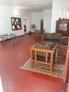 a room with chairs and tables in a building at Kandy Breeze Stay in Urulewatta