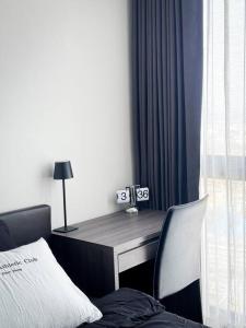 a bedroom with a desk with a bed and a chair at HMJ4 2BR stylish apartment on 36th floor KKC City center in Khon Kaen