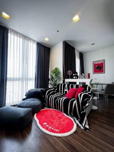a living room with a bed and a red rug at HMJ4 2BR stylish apartment on 36th floor KKC City center in Khon Kaen