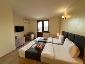 a bedroom with a large bed and a couch at The Hill Guest House in Yerevan