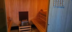 a small room with a fireplace in a sauna at Le Porteur de Glace Classé 2 étoiles in Aulus-les-Bains