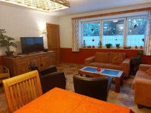 a living room with a couch and a tv at Holiday home-Aloisia 