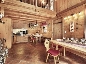 a kitchen with wooden walls and a table and chairs at at Haldensee Modern retreat in Grän