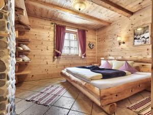 a bedroom with a bed in a log cabin at at Haldensee Modern retreat in Grän