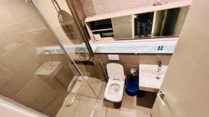 a small bathroom with a toilet and a sink at BBCC APARTMENT AT LUCENTIA 2 in Kuala Lumpur