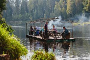 a group of people on a dock on a lake at Kempings Ozolkalns in Cēsis