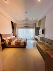 a large bedroom with a large bed and a couch at Grand Sri Lounge - Ocean Breeze Hotel residents in Negombo