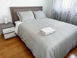 a bedroom with a bed with two towels on it at Brand New 2 Bed, 1 Bath Condo in Zadar