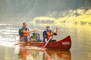 a group of people in a canoe on a lake at Kempings Ozolkalns in Cēsis