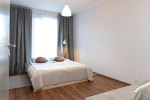 a bedroom with a bed in front of a window at Jaamamõisa apartement in Tartu