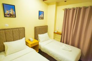 Postel nebo postele na pokoji v ubytování Raim Hotel