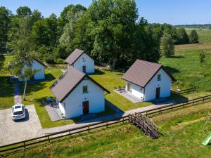 an aerial view of two houses in a field at Comfortable holiday homes for 6 people in Lędzin