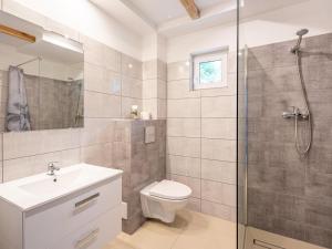 a bathroom with a toilet sink and a shower at Comfortable holiday homes for 6 people in Lędzin