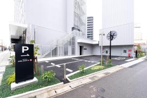 a parking lot in front of a building at Hotel JAL City Toyama in Toyama