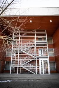 a building with a metal staircase on the side of it at Jaamamõisa apartement in Tartu
