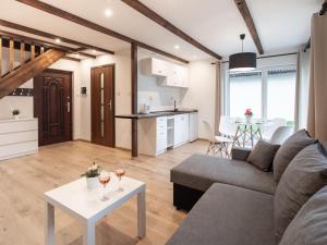 a living room with a couch and a table with wine glasses at Brick Cottage near Baltic Sea and Windmill in Lędzin +12 photos