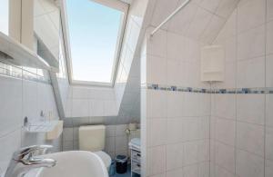 a bathroom with a sink and a toilet and a window at DZ 11 Doppelzimmer in Heringsdorf