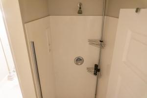 a shower in a bathroom with two hoses at Beach Front Destin Condo Daily Beach Service - Blue Dolphin in Fort Walton Beach