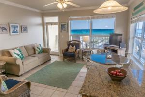 a living room with a couch and a table at Beach Front Destin Condo Daily Beach Service - Blue Dolphin in Fort Walton Beach