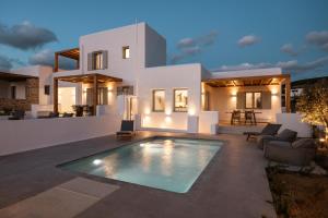 a villa with a swimming pool in front of a house at P square Luxury villas Naxos in Kastraki Naxou