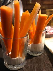 two glasses filled with orange carrots on a table at Stebuklas in Vilnius