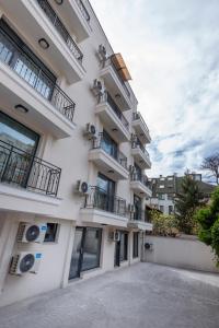 a large white building with balconies on it at Best Guest 2 Apartments in Plovdiv