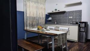 a kitchen with a table and chairs in a room at Kalia Cottage in Batu