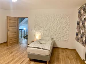ein Schlafzimmer mit einem Bett und einem großen Wandgemälde in der Unterkunft Folwark Sudecki in Marciszów