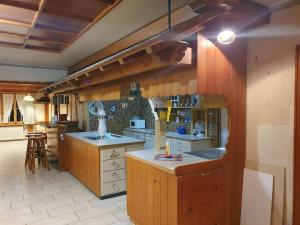 a large kitchen with wooden cabinets and a counter at Aufschnaufhof in Diemtigen