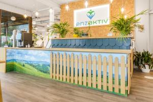 a reception counter with a fence and plants at Ferienwohnung Kuckucksnest in Bad Wildbad