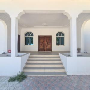 a entrance to a house with a wooden door at سكن مريح in Dubai