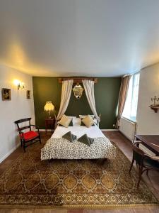 a bedroom with a bed with a canopy at Les Florentines in Carcassonne