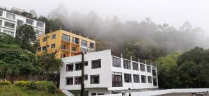 a white building in front of a mountain at SKY VIEW RESORTS in Munnar