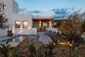 a villa with a swimming pool at dusk at P square Luxury villas Naxos in Kastraki Naxou