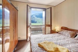 a bedroom with a bed and a large window at Bormio 1 in Santa Lucia