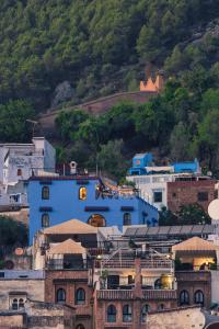 a group of blue buildings on a hill at Dar Zambra in Chefchaouen
