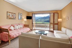 a living room with a couch and a large window at Bormio 1 in Santa Lucia
