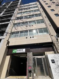 a building with a sign in front of it at MANGA ART HOTEL, BAKUROCHO in Tokyo