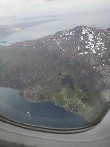 una vista aérea de una montaña y un lago desde un avión en Hytte på telnes (Sandhornøy), en Finnset
