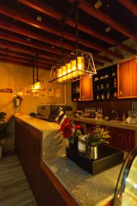 a kitchen with a counter with flowers and lights at Raim Hotel in Pagadian