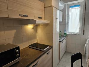 a small kitchen with a sink and a stove at 2 letti singoli a linea M1 Sesto Rondo' in Sesto San Giovanni