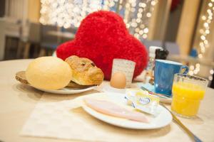 a table with a plate of food and a red heart at Ostend Hotel in Ostend